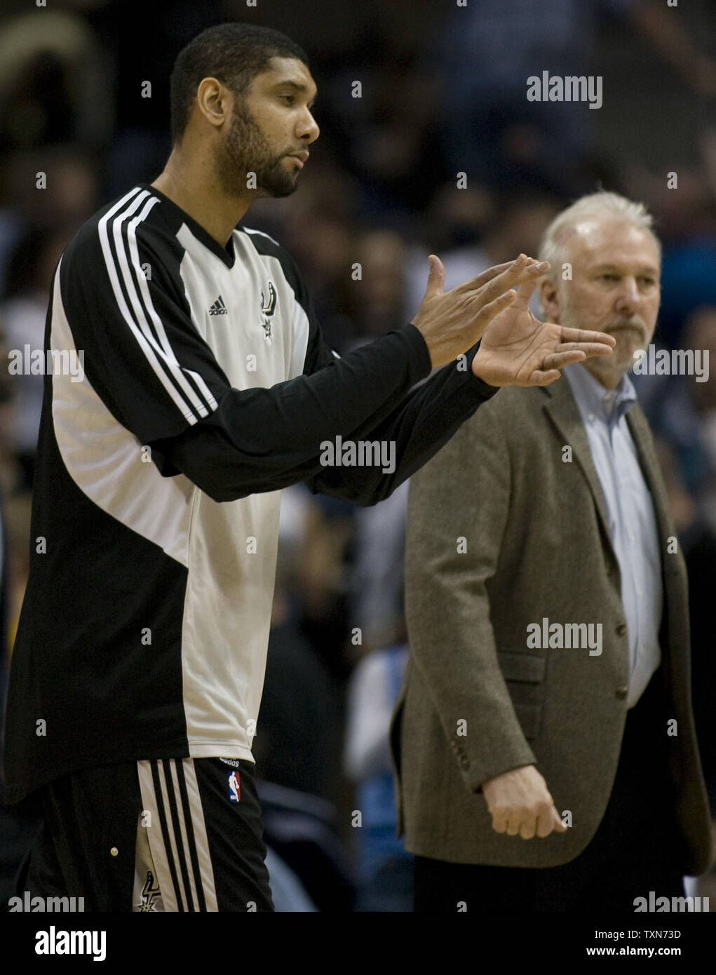 San Antonio Spurs head coach Gregg Popovich talks with star Tim Duncan late  in the fourth quarter against the Denver Nuggets at the Pepsi Center in  Denver on April 10, 2013. Denver