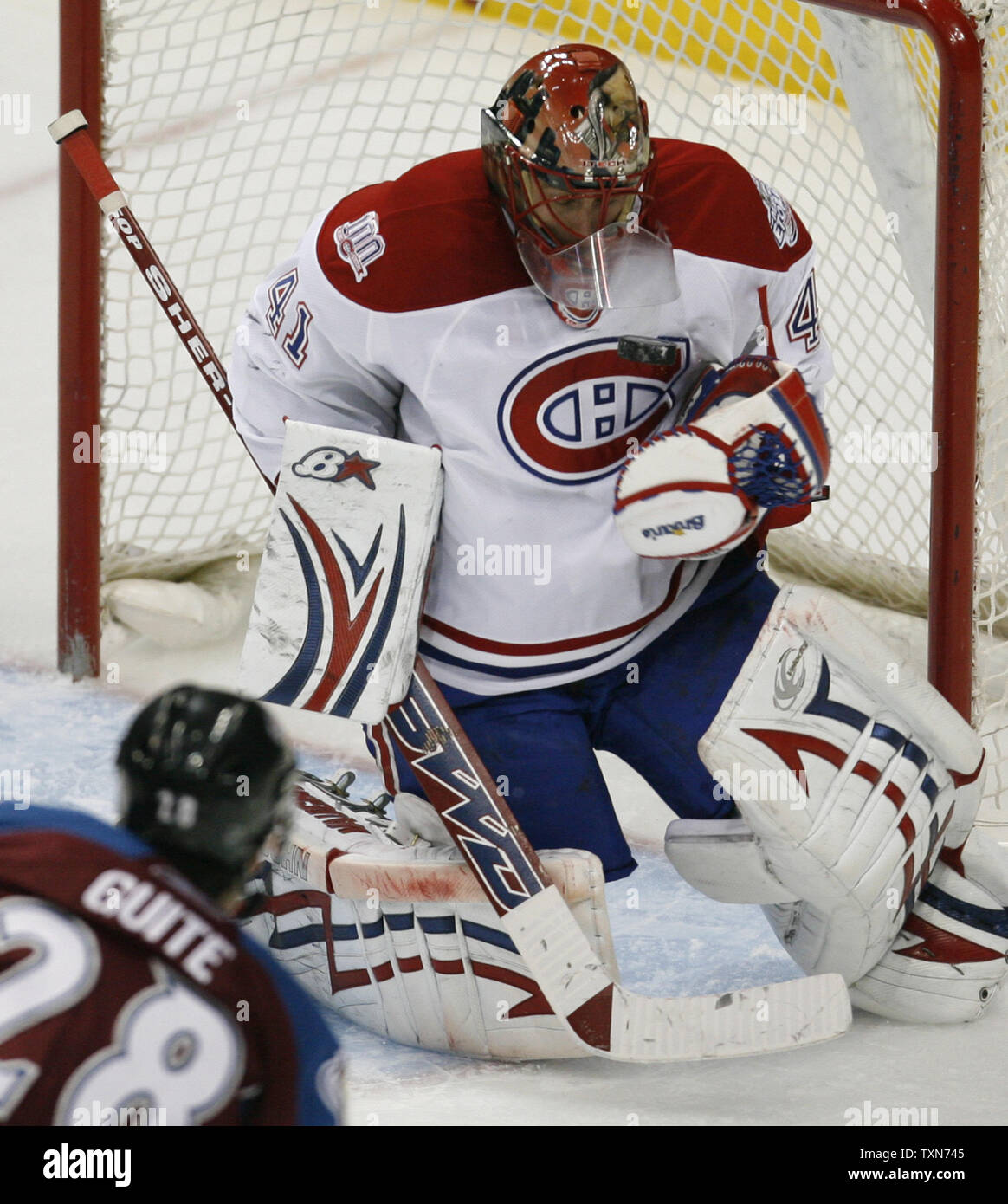 As the goal light flashes, Montreal Canadiens goalie Jaroslav Halak, of  Slovakia, fishes the puck out of the back of the net after a Boston Bruins  goal during the second period of