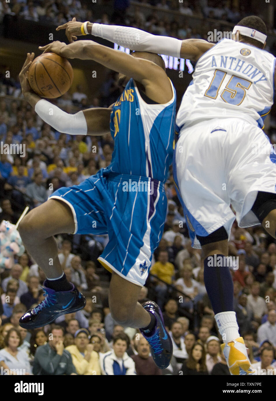 Denver Nuggets forward Carmelo Anthony (L) keeps the ball away