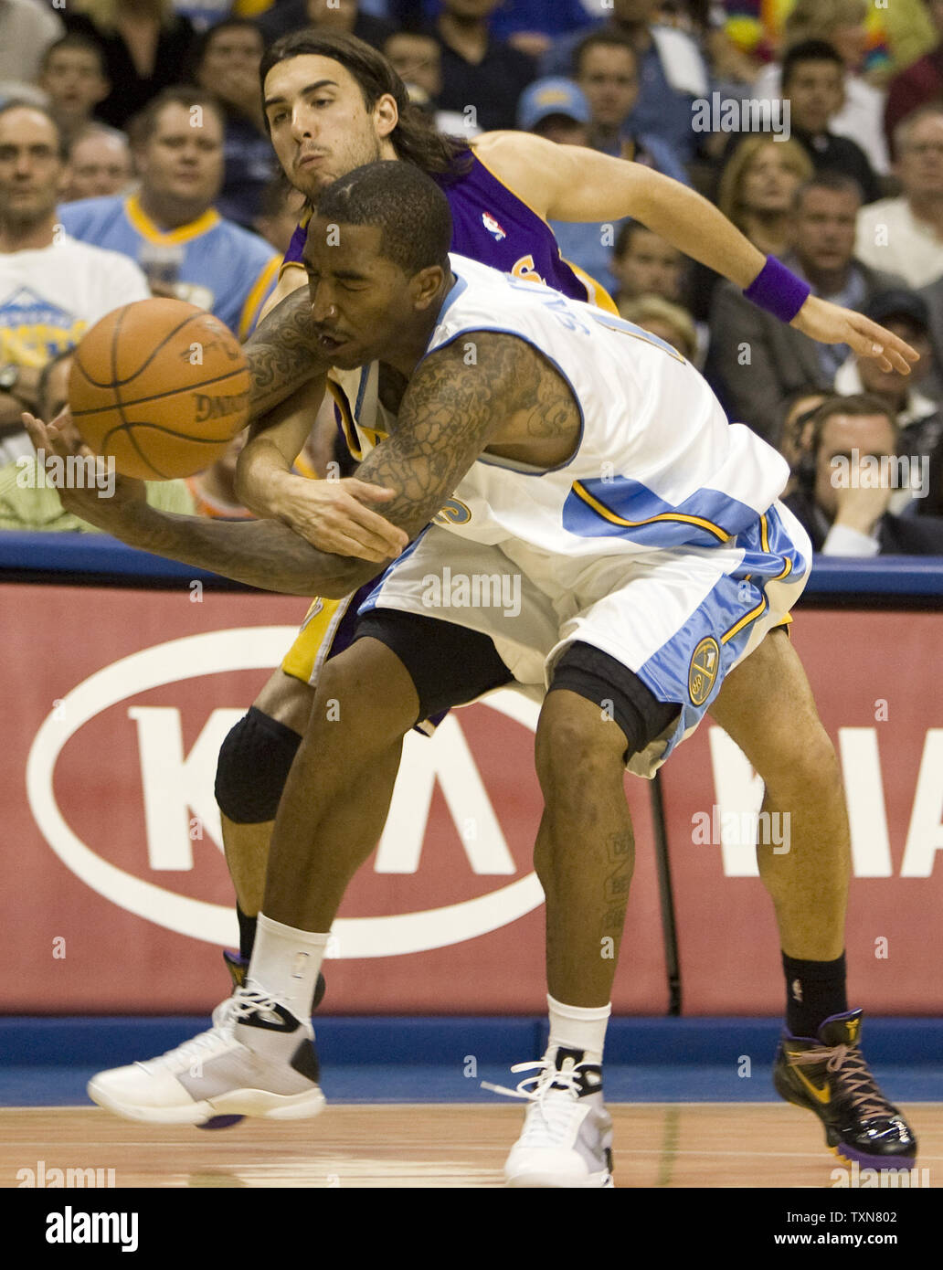 Los Angeles Lakers guard Sasha Vujacic (back) fouls Denver Nuggets guard J.R. Smith on an inbounds pass in the second half of game three of the Western Conference finals at the Pepsi Center in Denver on May 23, 2009.  .Los Angeles beat Denver 103-97 to take a 2-1 series lead.  (UPI Photo/Gary C. Caskey) Stock Photo