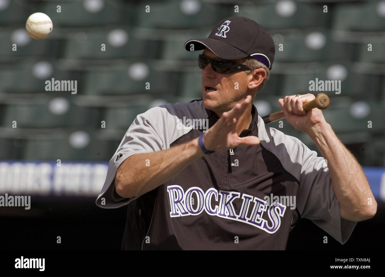Colorado Rockies manager Jim Tracy hits infield practice at Coors Field in Denver on July 3. 2009.  Tracy has been credited for the recent Rockies winning streaks due to his clubhouse presence and a more relaxed atmosphere.    (UPI Photo/Gary C. Caskey) Stock Photo