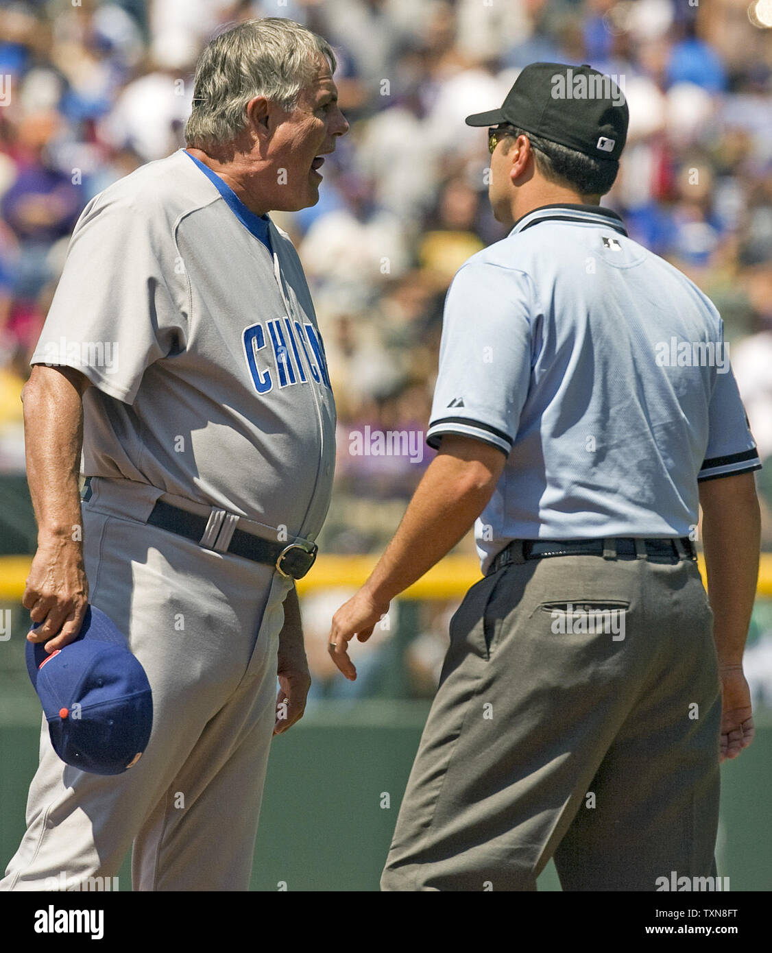 Chicago Cubs manager Lou Piniella argues the call on the second inning ending double play call against the Colorado Rockies at Coors Field in Denver on August 9, 2009.  Umpire Angel Campos keeps Piniella from approaching second base umpire Chris Guccione.      UPI/Gary C. Caskey... Stock Photo