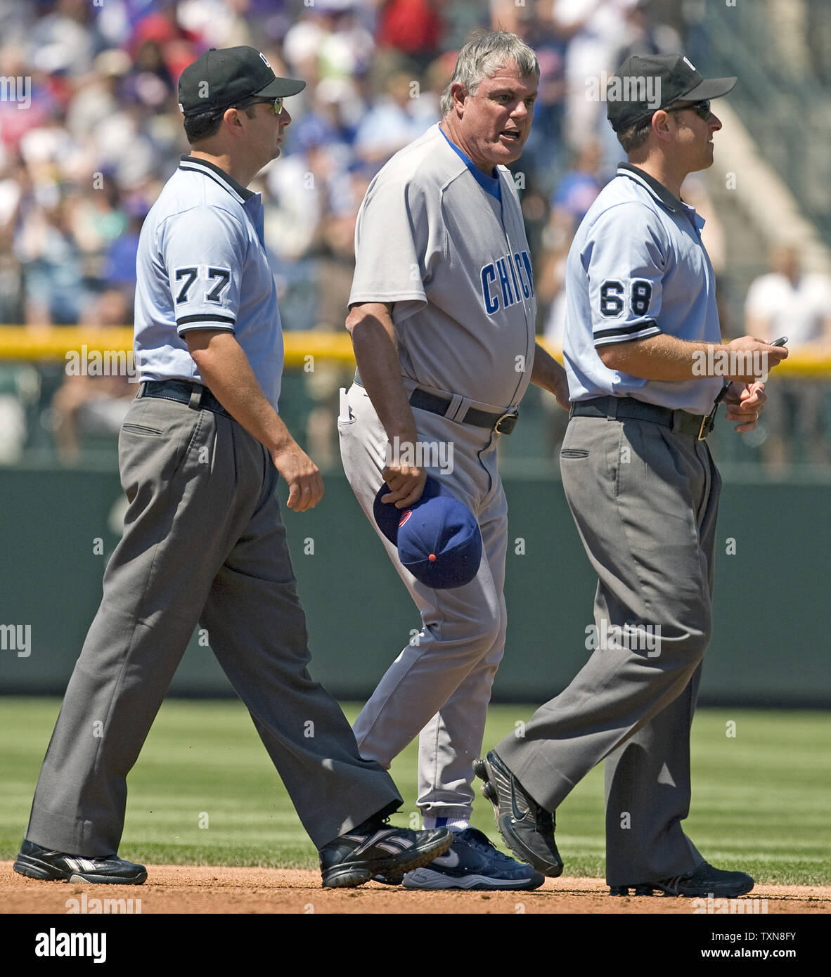 Chicago Cubs manager Lou Piniella (C) chases second base umpire Chris Guccione while trailed by first base umpire Jim Reynolds during the second inning against the Colorado Rockies at Coors Field in Denver on August 9, 2009.  Piniella was ejected for arguing the call on a double play that ended the inning for the Cubs.     UPI/Gary C. Caskey... Stock Photo