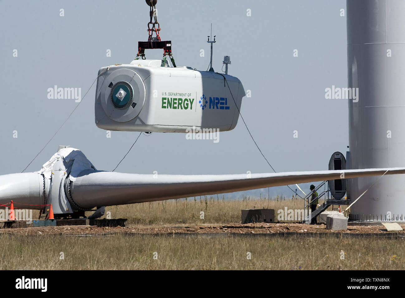 The nacelle containing a new 1.5 megawatt GE wind turbine rises above