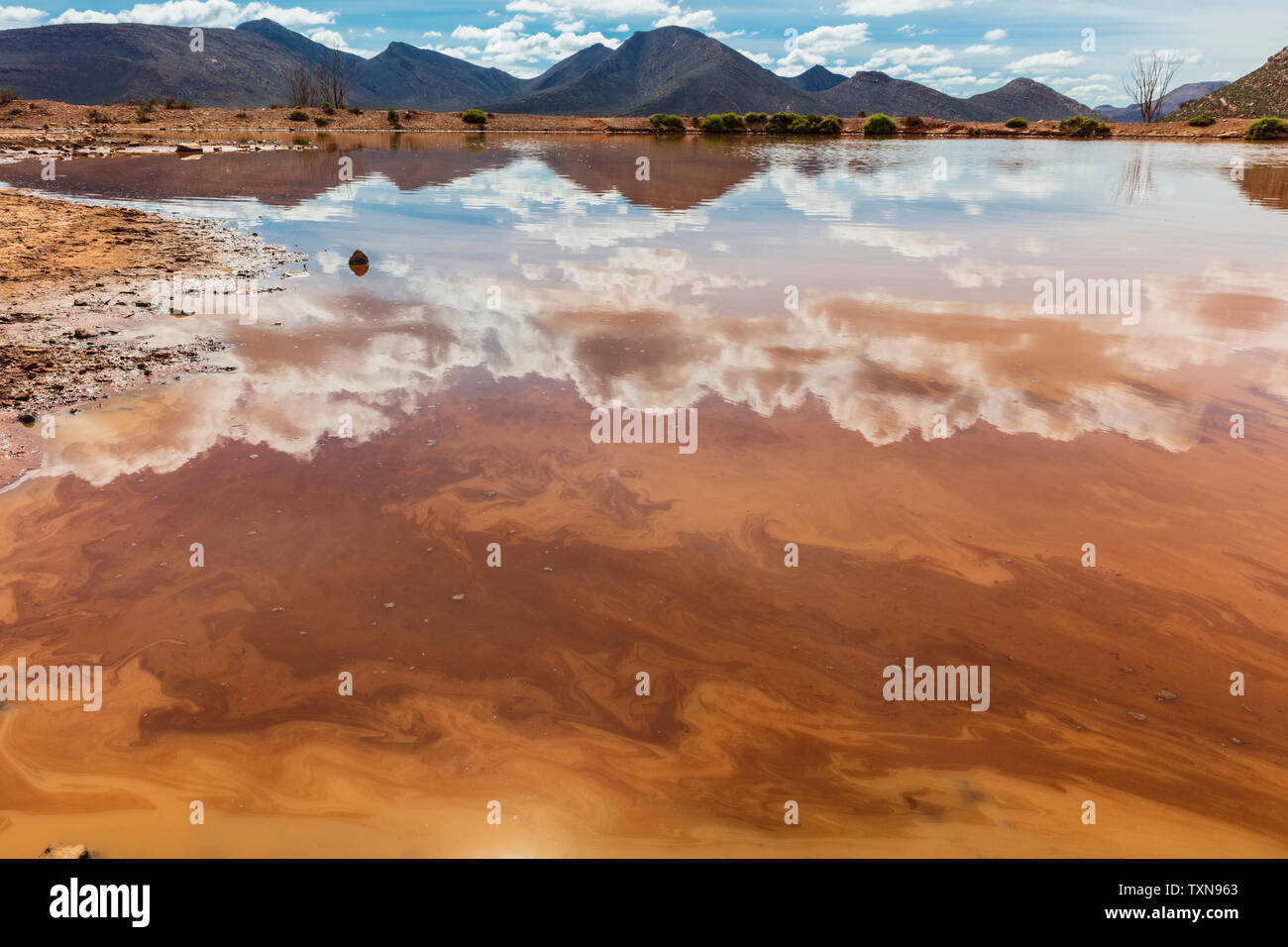 Reflection of cloudscape in lake, mountain ranges in background, Cape Town, Western Cape, South Africa Stock Photo