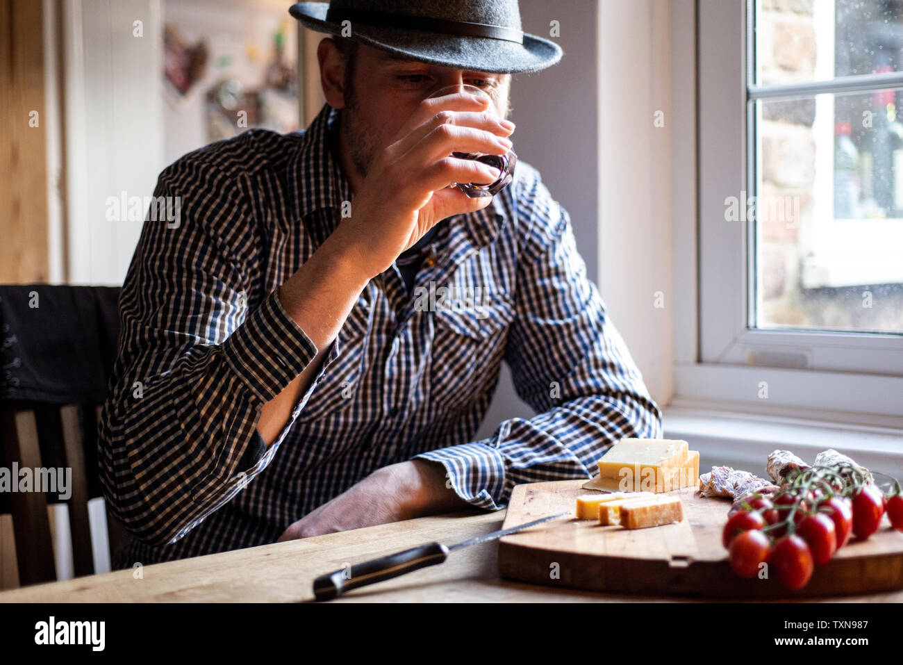 Man drinking wine and eating mediterranean food in cafe Stock Photo