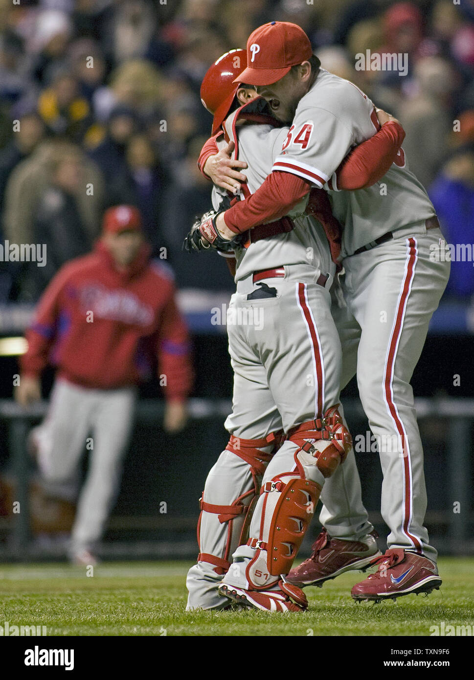 Philadelphia Phillies pitcher Brad Lidge (R) hugs catcher Carlos Ruiz after  striking out Colorado Rockies shortstop Troy Tulowitki to preserve the  Phillies come from behind win during game four of the National