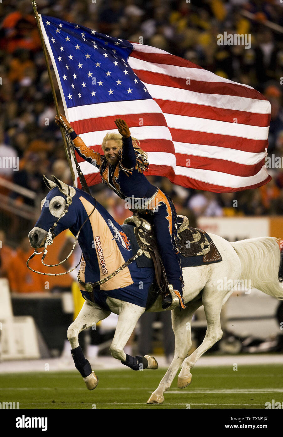 Ann Judge-Wegener rides the Denver Broncos mascot, Thunder, after the Broncos scored against the Pittsburgh Steelers during the first quarter at Invesco Field at Mile High in Denver on November 9, 2009.       UPI/Gary C. Caskey... Stock Photo
