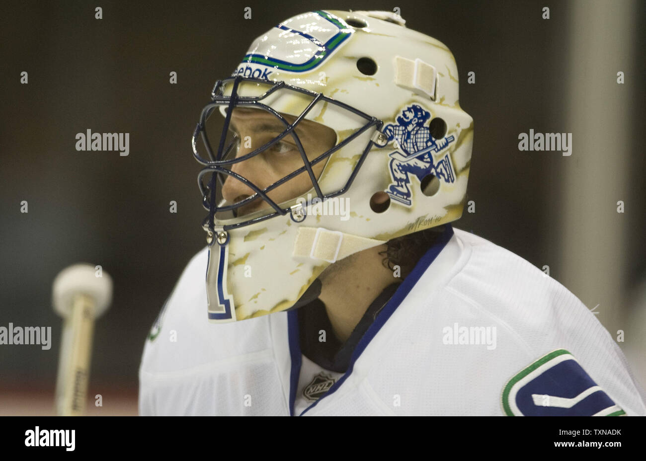 Goalie Roberto Luongo of the Vancouver Canucks gets his helmet