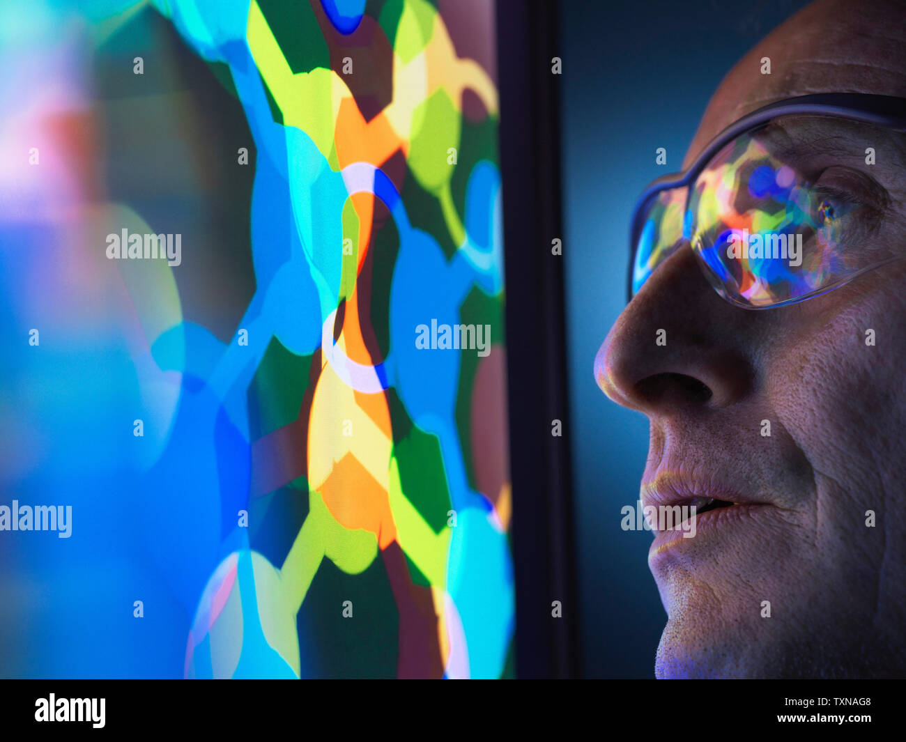 Scientist understanding the design of a molecular structure on computer screen in laboratory Stock Photo
