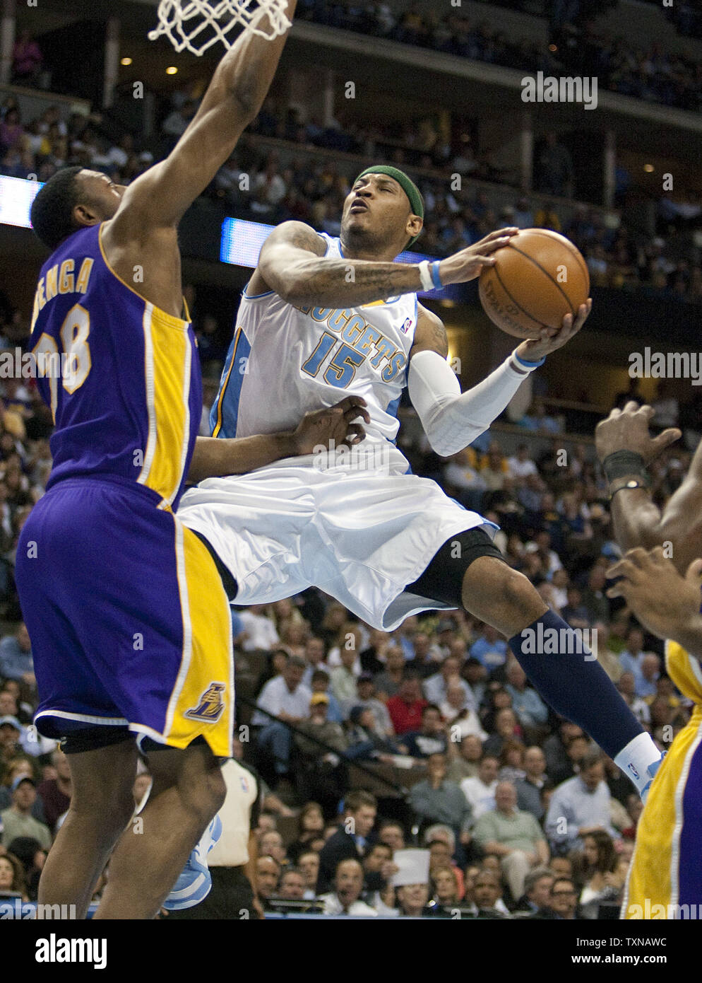 Denver Nuggets Forward Carmelo Anthony 15 Drives Against Los Angeles Lakers Dj Mbenga During The First Quarter At The Pepsi Center On April 8 2010 In Denver The Lakers Currently Lead The