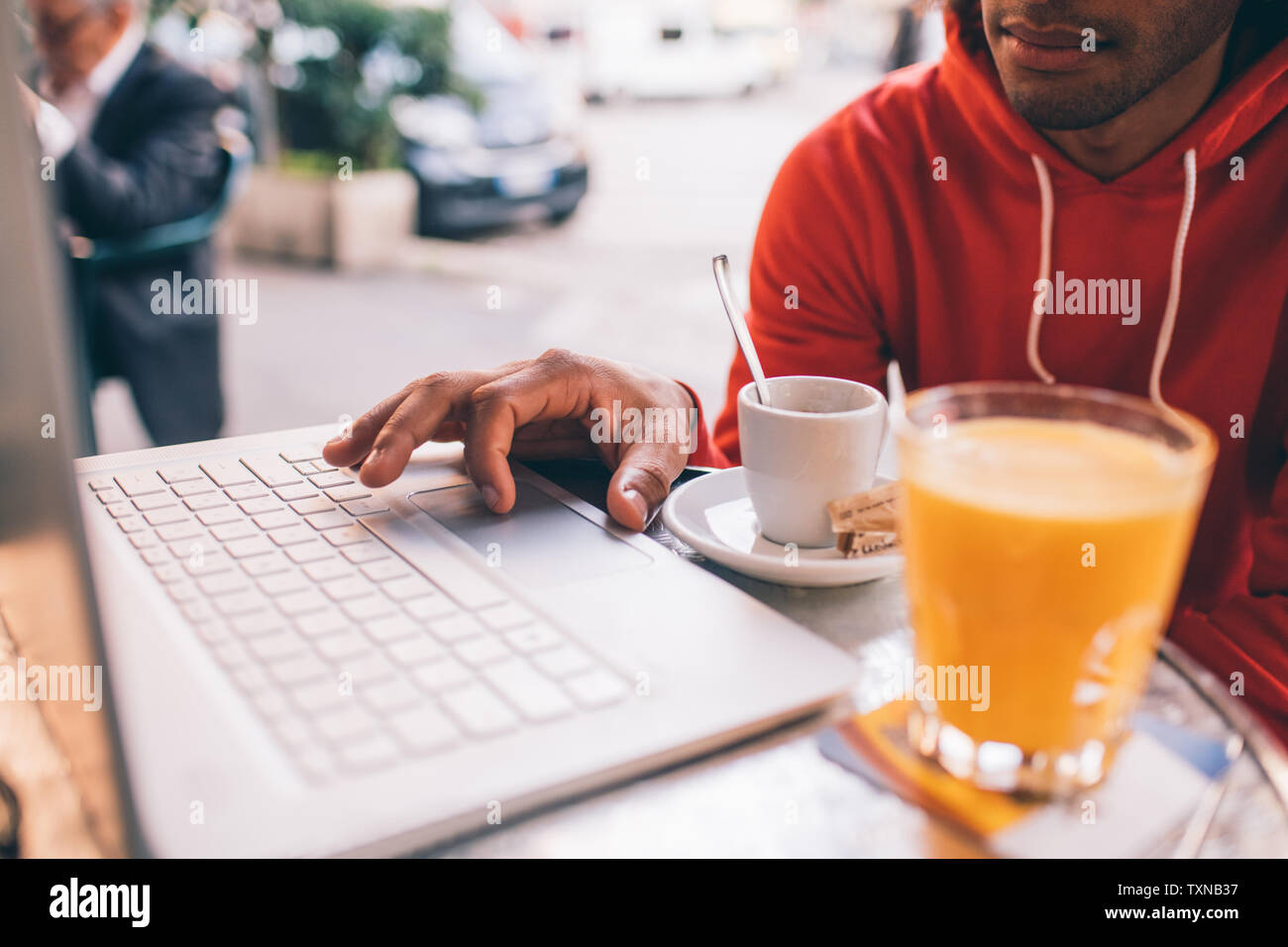 Young man using laptop at cafe Stock Photo