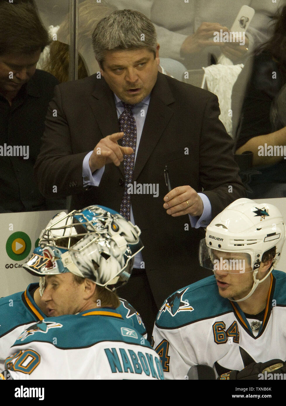 San Jose Sharks head coach Todd McLellan (top) instructs during a time out against the Colorado Avalanche in game six of the NHL quarterfinal playoffs at the Pepsi Center on April 24, 2010 in Denver.  Sharks goalie Nabokov stands in the foreground.   San Jose leads Colorado 3-2 in the series.       UPI/Gary C. Caskey Stock Photo