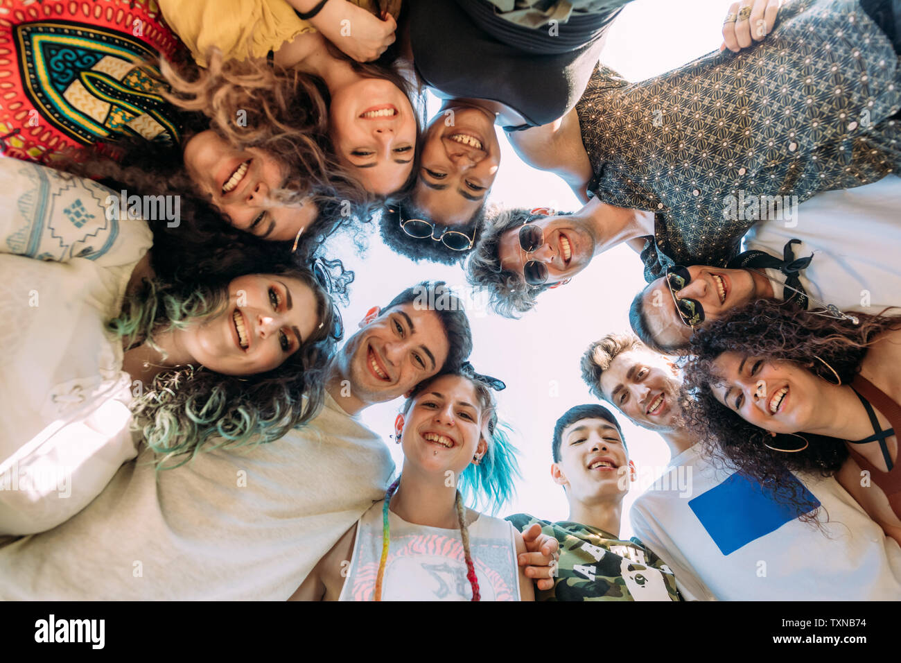 Group of friends smiling in circle Stock Photo - Alamy