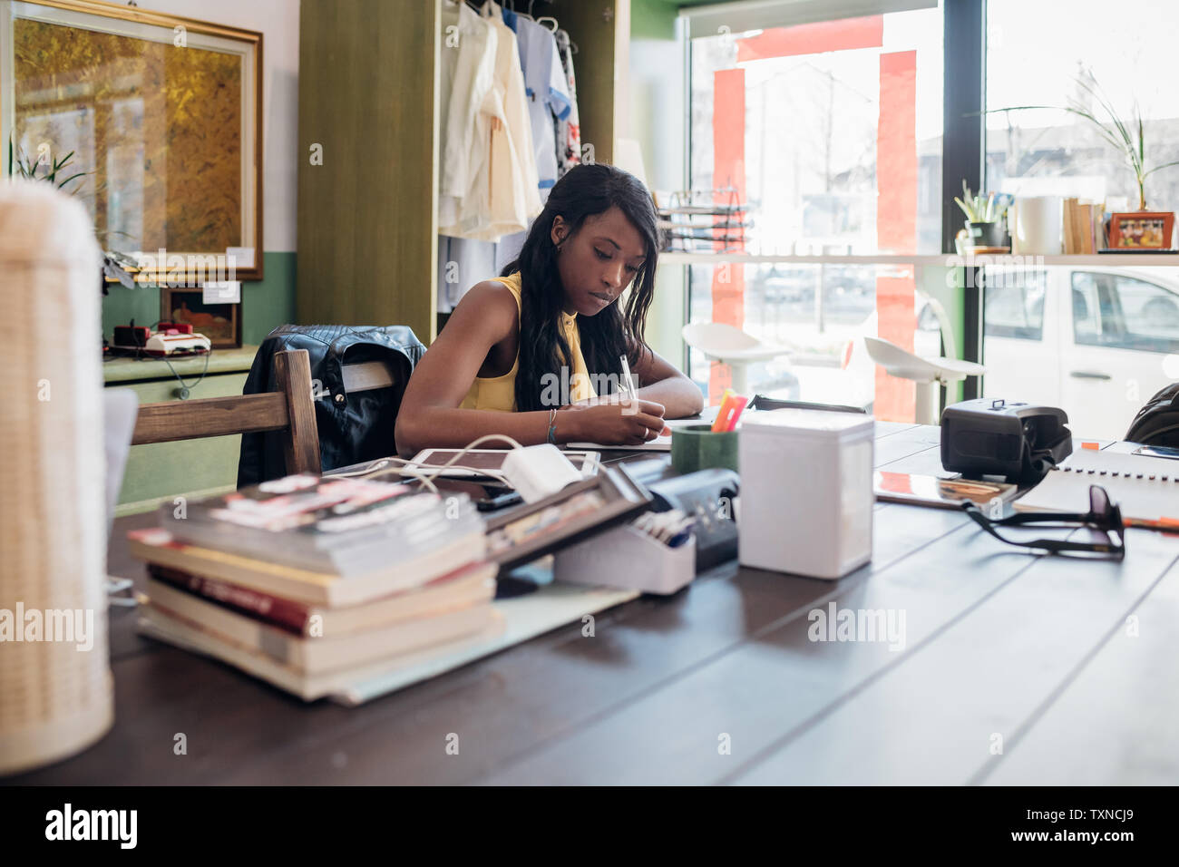 Young businesswoman remote working at cafe table Stock Photo