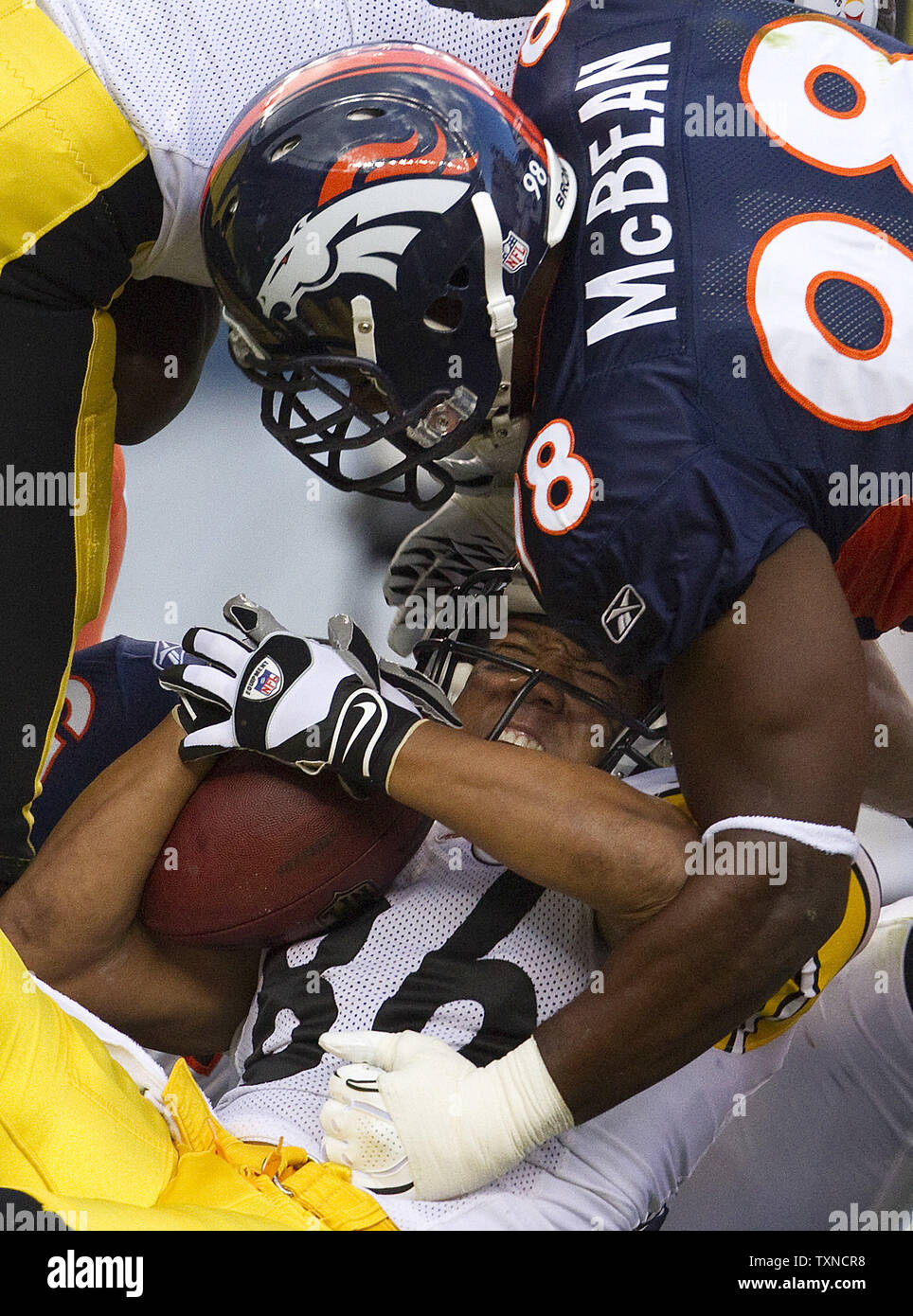 Denver Broncos defensive end Ryan McBean tackles Pittsburgh Steelers wide receiver Hines Ward after a short pass reception during the first half at Invesco Field at Mile High on August 29, 2010 in Denver.  UPI/Gary C. Caskey Stock Photo