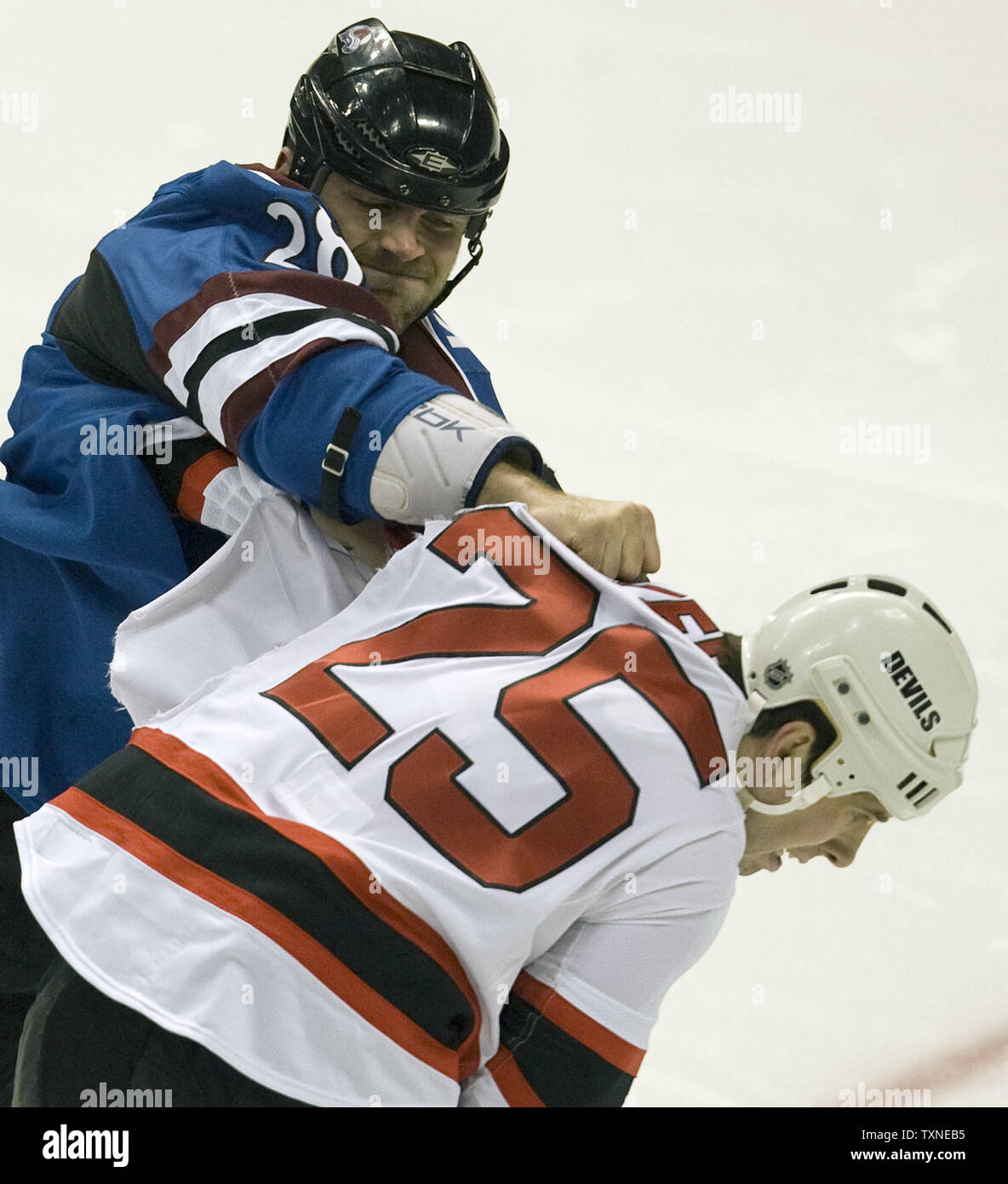 Colorado Avalanche David Koci (L) and New Jersey Devils Andrew Peters  engage in an early fight drawing five-minute fighting penalties during the  first period at the Pepsi Center in Denver on January