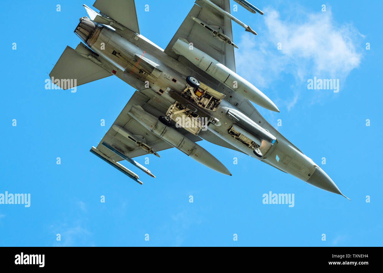 Dutch F-16 fighter plane taking part in NATO exercise Frysian flag, low angle against blue sky, Netherlands Stock Photo