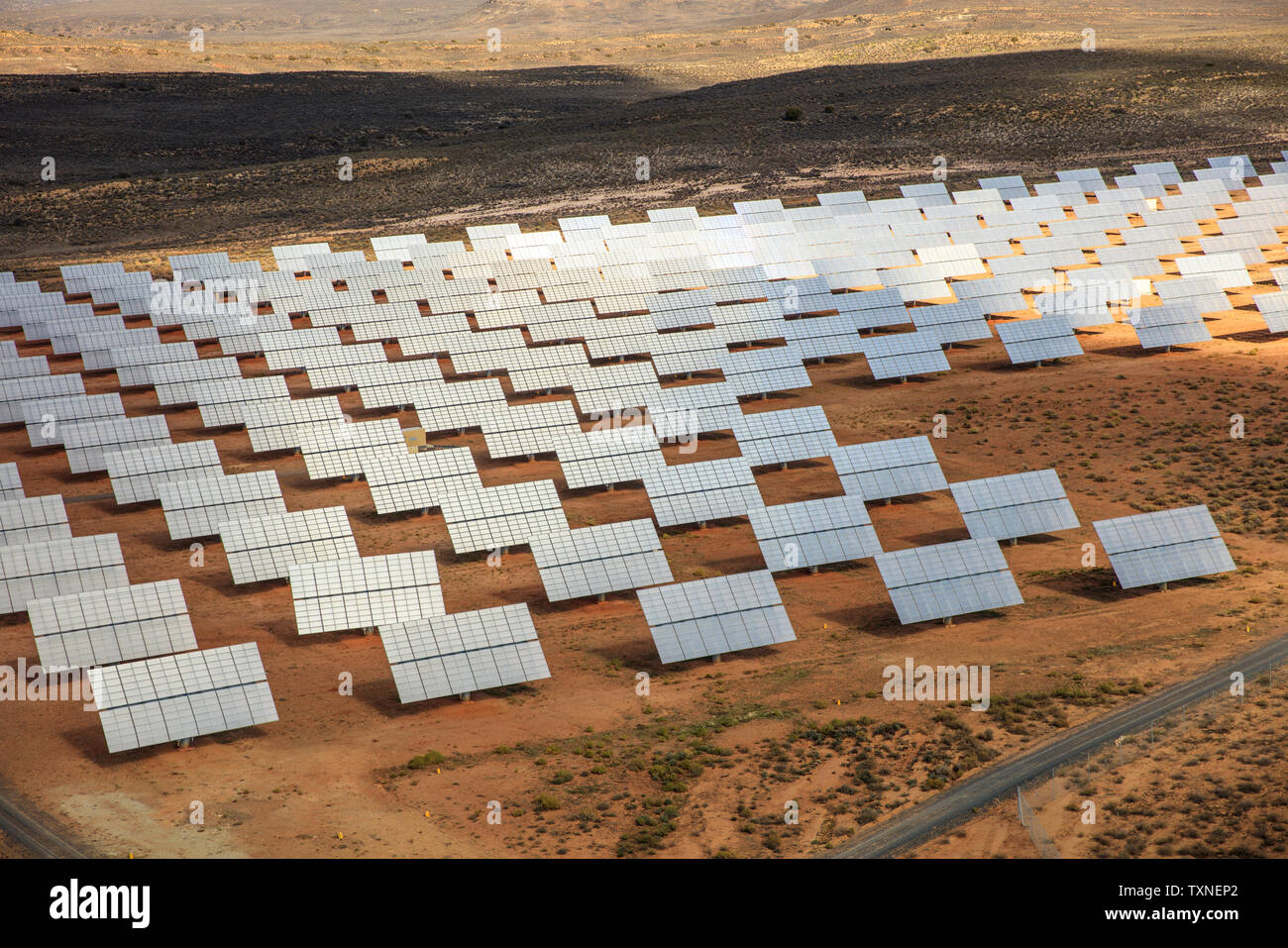 Rows of solar panels in arid landscape, aerial view, Cape Town, Western