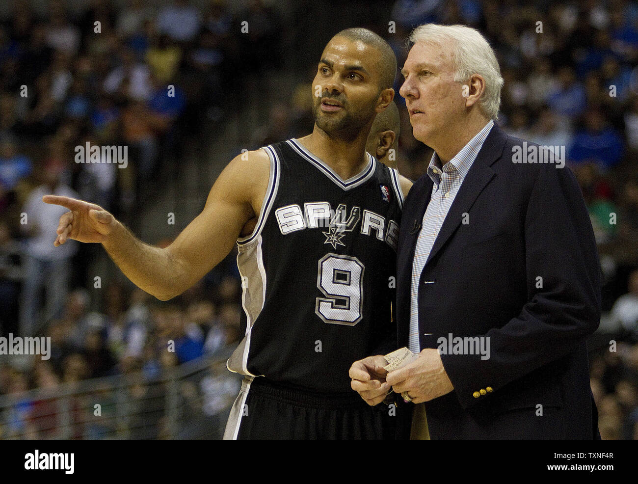 San Antonio Spurs head coach Gregg Popovich talks with star Tim Duncan late  in the fourth quarter against the Denver Nuggets at the Pepsi Center in  Denver on April 10, 2013. Denver