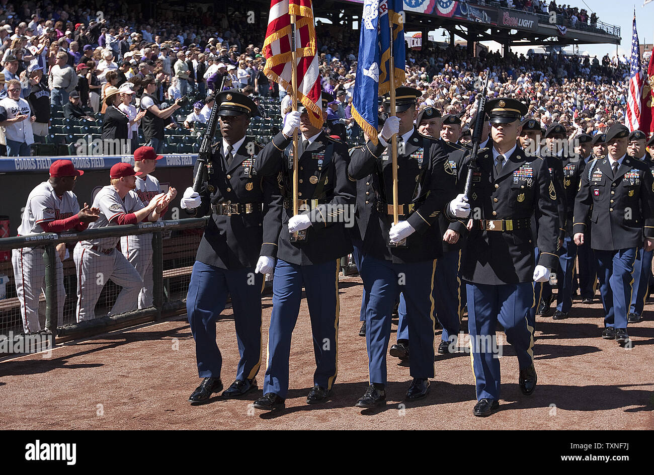 A military parade with the US Army, US Air Force, US Navy, and the US Marines started pre-game ceremonies at Coors Field on Opening Day in Denver on April 1, 2011.  A moment of silence was held for the victims of the Japanese tsunami disaster.     UPI/Gary C. Caskey Stock Photo