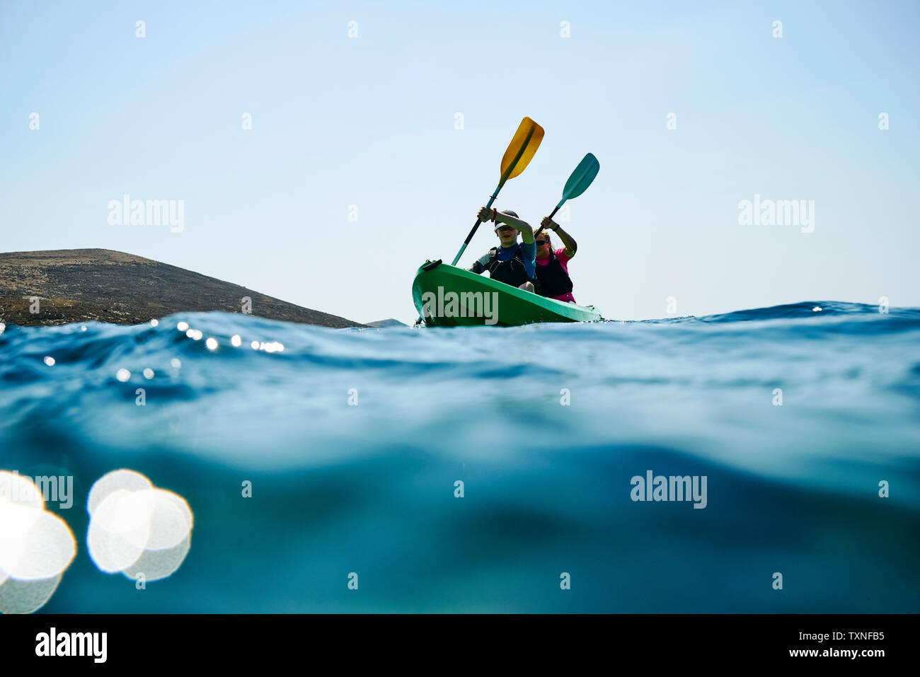 Teenage boy and mother sea kayaking, surface level view, Limnos, Khios, Greece Stock Photo
