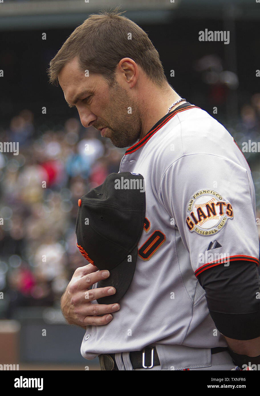 San Francisco Giants third baseman Mark DeRosa bows his head during a moment of silence for baseball great Harmon Killebrew at Coors Field in Denver on May 17, 2011.    UPI/Gary C. Caskey Stock Photo