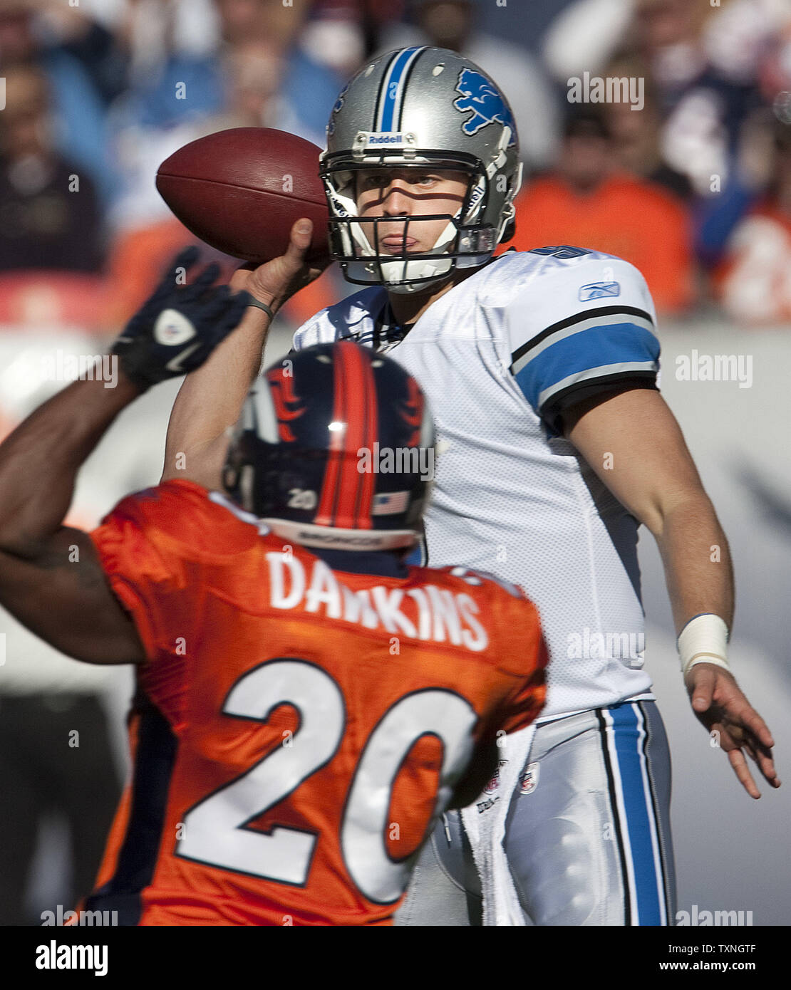 Detroit Lions quarterback Matthew Stafford throws over Denver Broncos safety Brian Dawkins at Sports Authority Field at Mile High in Denver on October 30, 2011.     UPI/Gary C. Caskey Stock Photo