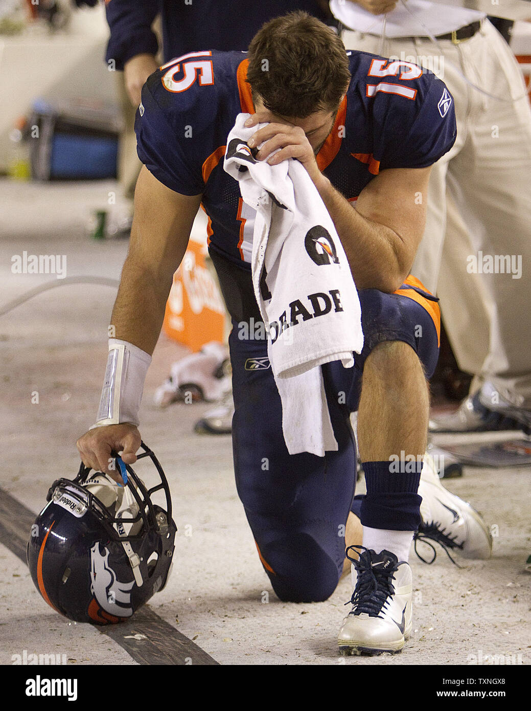 Denver Broncos Quarterback Tim Tebow Prays In The Bench Area With