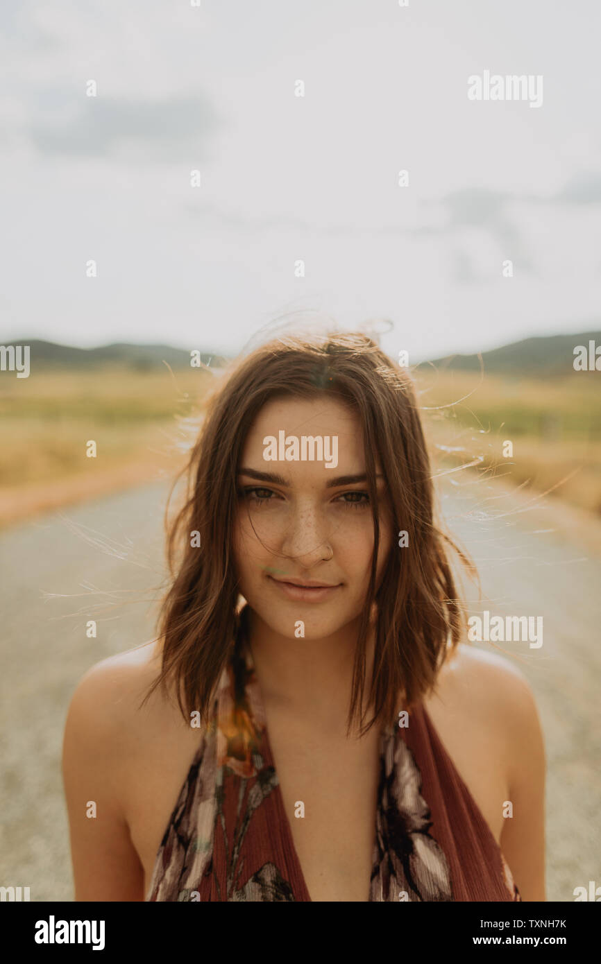 Young woman on rural road, head and shoulder portrait, Exeter, California, USA Stock Photo