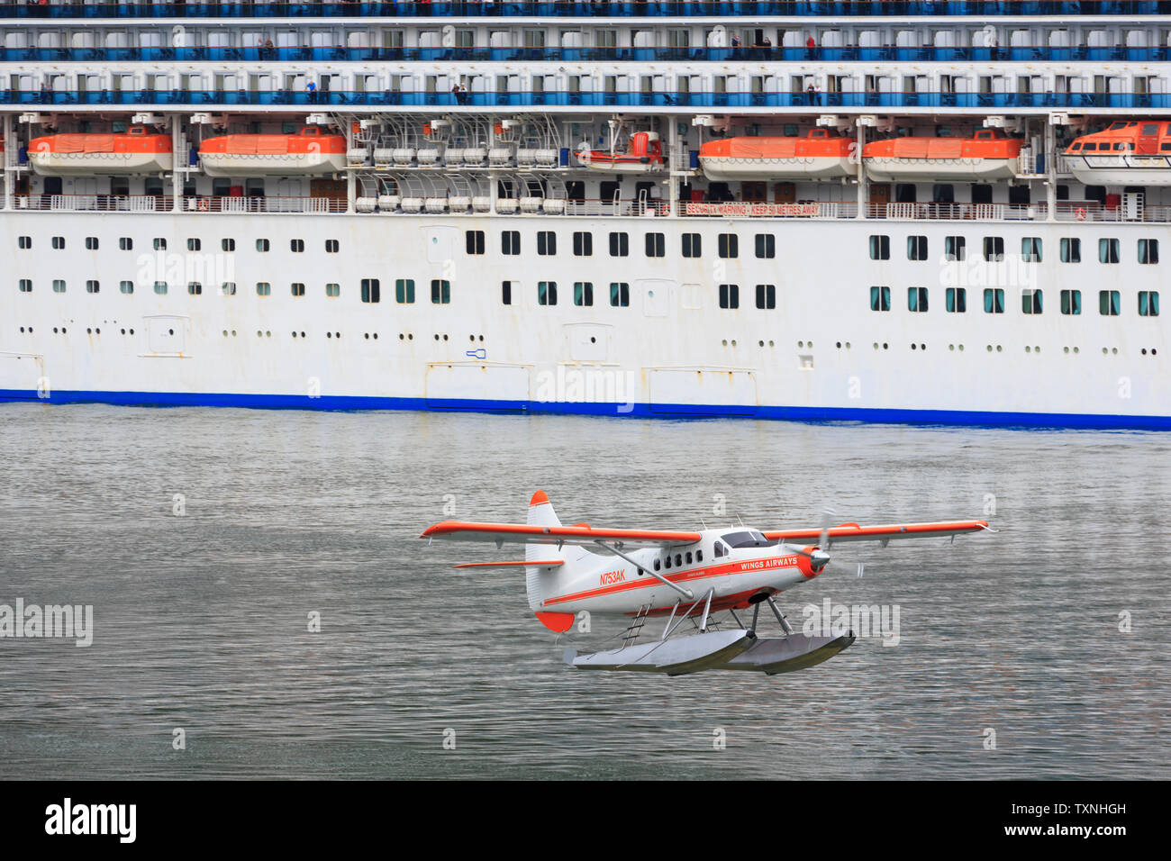 Float plane passing Cruise Ship, Juneau, Alaska, USA Stock Photo Alamy