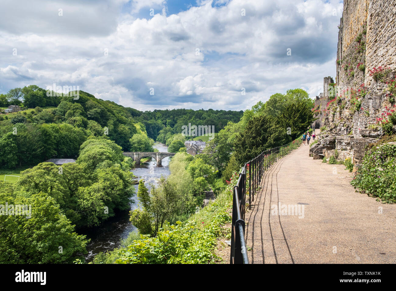Richmond Castle walls and the Castle Walk footpath above the River Swale in in Yorkshire Dale country North Yorkshire Stock Photo