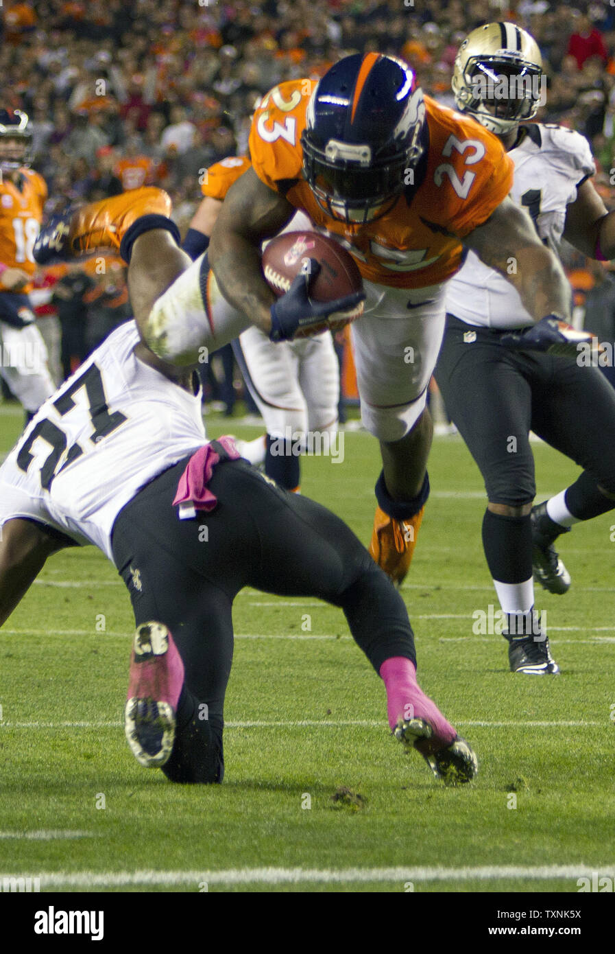 Denver Broncos running back Willis McGahee (L) scores against Buffalo Bills  linebacker Reggie Torbor on a 13-yard touchdown pass in the second quarter  at Sports Authority Field at Mile High in Denver