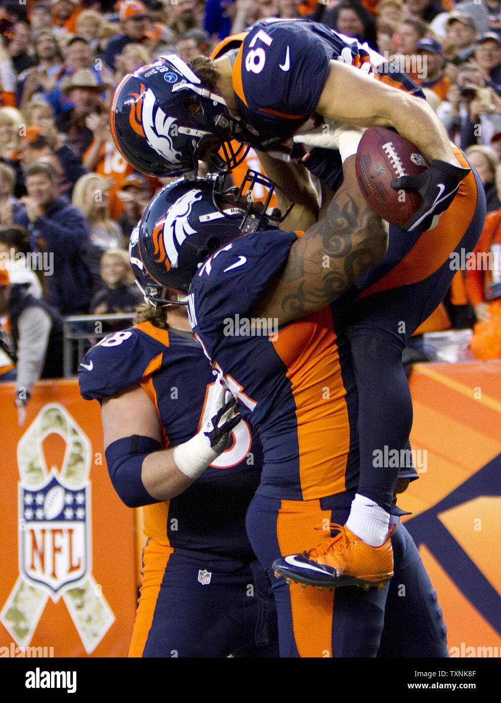 Denver Broncos wide receiver Eric Decker touches helmets with tackle  Orlando Franklin after lifted in the air after scoring on a 20-yard third  quarter touchdown against the San Diego Chargers at Sports, image size:991x1390