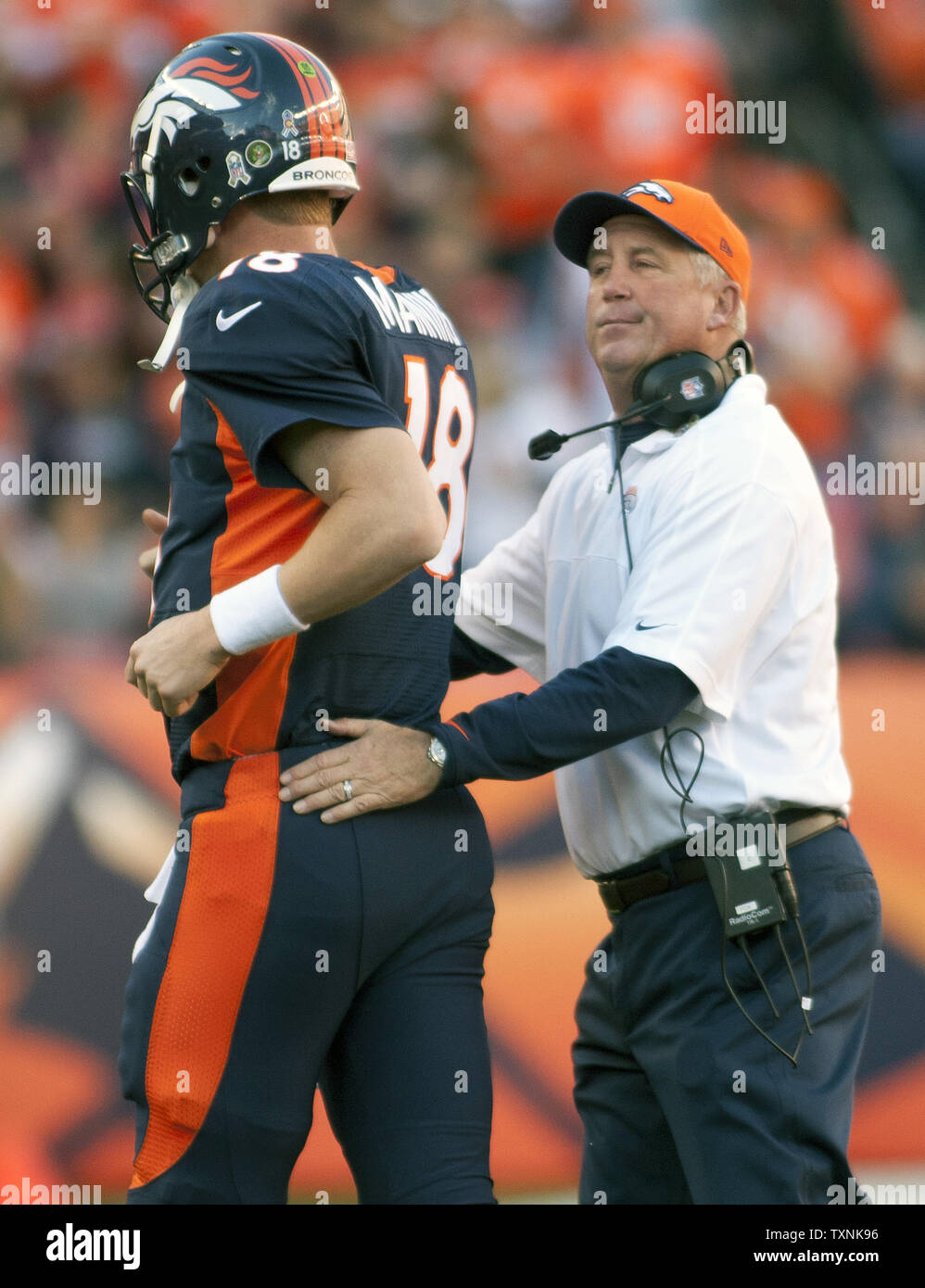 Denver Broncos head coach John Fox congratulates quarterback Peyton Manning after his second quarter touchdown pass gave him sole possession of second place for the NFL's most touchdown passes during the game against the San Diego Chargers at Sports Authority Field at Mile High on November 18, 2012 in Denver.  Manning passed Miami Dolphins quarterback Dan Marino.    UPI/Gary C. Caskey Stock Photo