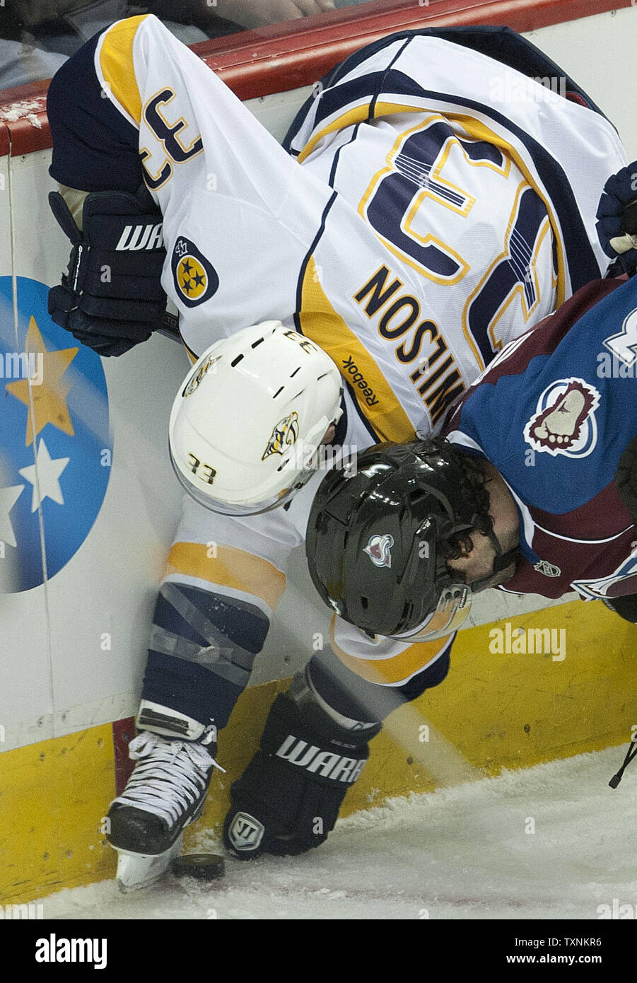Nashville Predators center Colin Wilson (33) and Colorado Avalanche defenseman Ryan O'Byrne  battle for a loose puck behind the Avalanche goal during the second  period at the Pepsi Center on February 18, 2013 in Denver.   UPI/Gary C. Caskey Stock Photo