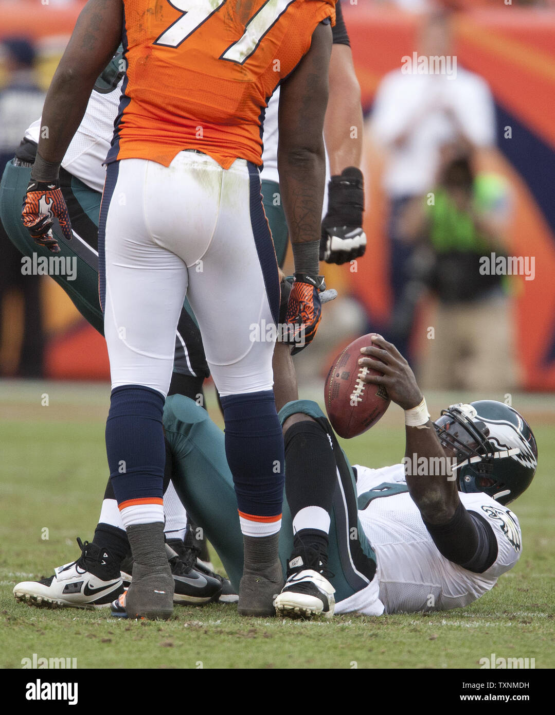 Denver Broncos Robert Ayers stands over sacked Philadelphia Eagles quarterback Michael Vick at the end of the third quarter at Sports Authority Field at Mile High in Denver on September 29, 2013.  Denver (4-0) beat Philadelphia (1-3) 52-20 to remain undefeated.     UPI/Gary C. Caskey Stock Photo