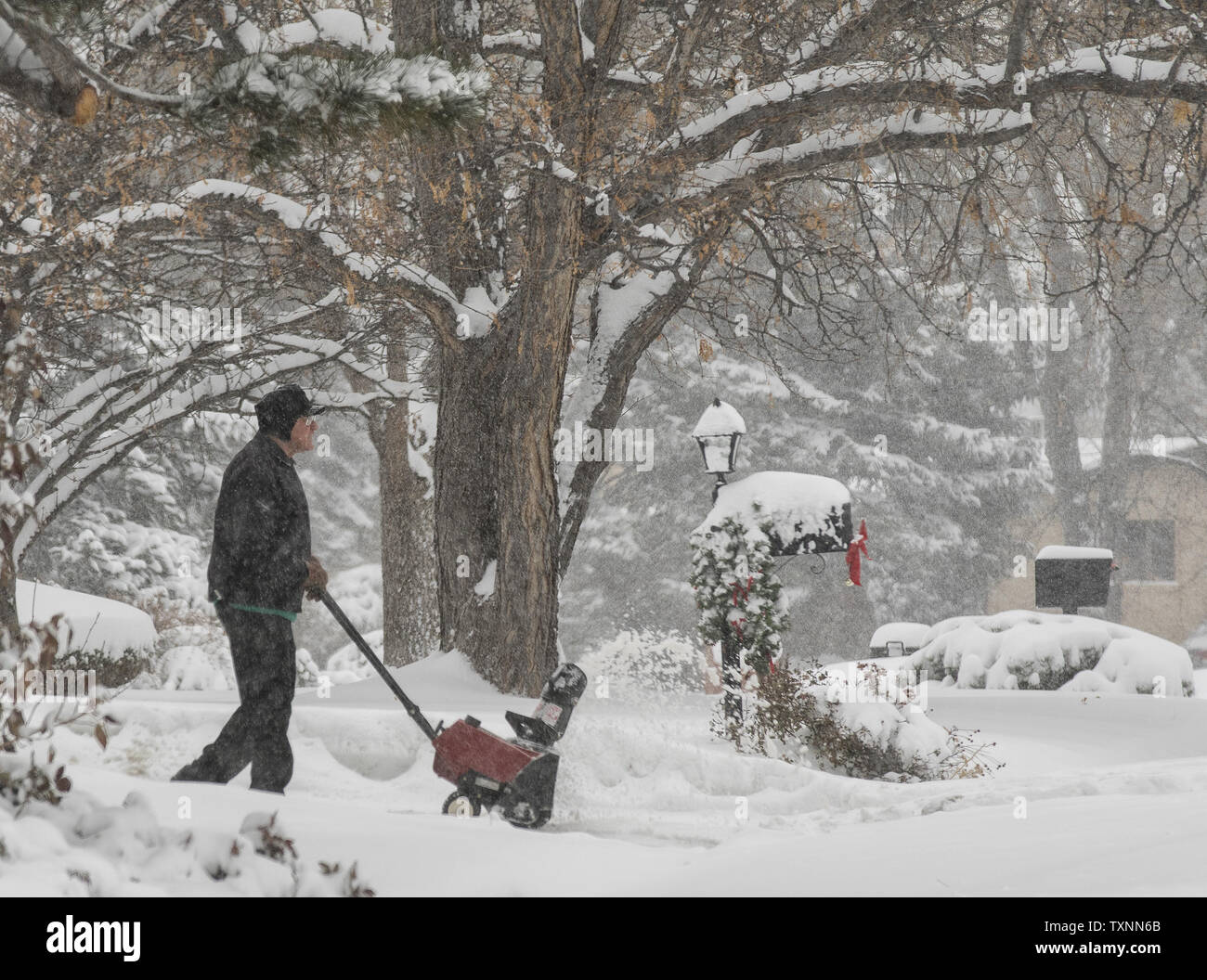 https://c8.alamy.com/comp/TXNN6B/an-elderly-man-using-a-small-snow-blower-enjoys-the-beauty-as-snow-covers-his-neighborhood-during-a-winter-storm-in-denver-on-december-15-2015-the-snowfall-has-reached-ten-inches-in-parts-of-metro-denver-photo-by-gary-c-caskeyupi-TXNN6B.jpg