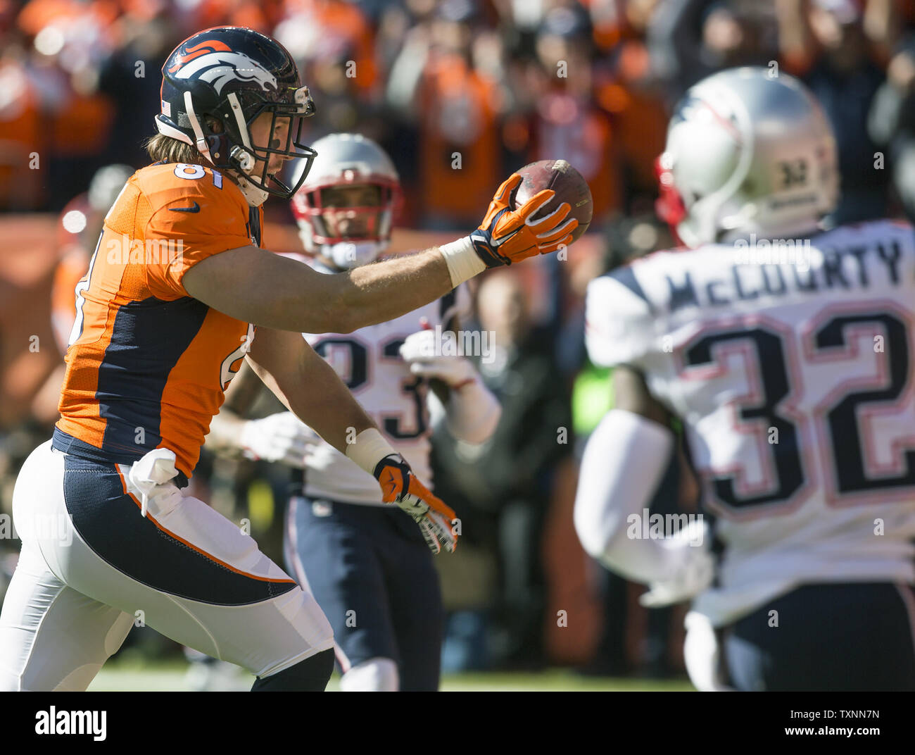Denver Broncos tight end Owen Daniels crosses the goal line on a 21-yard touchdown against the New England Patriots safeties Patrick Chung 923) and Devin McCourty in the first quarter during the AFC Championship game at Sport Authority Field at Mile High in Denver on January 24, 2016.    Photo by Gary C. Caskey/UPI Stock Photo