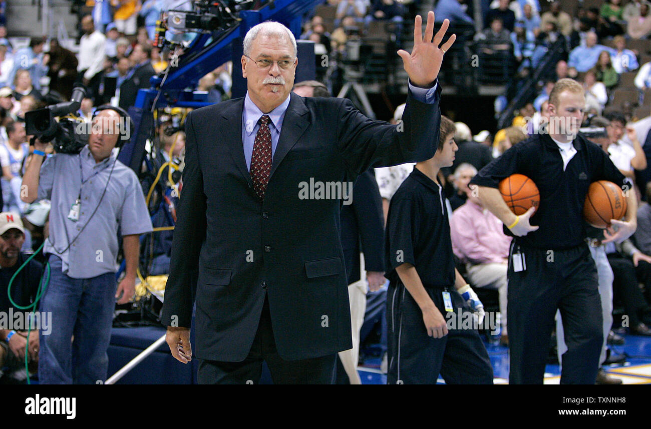 Los Angeles Lakers head coach Phil Jackson (C) waves upon entering the court to open his season with Kobe Bryant and the Lakers against the Denver Nuggets at the Pepsi Center in Denver November 2, 2005. Jackson is returning to coaching the Lakers after a year's absence.  (UPI Photo/Gary C. Caskey) Stock Photo