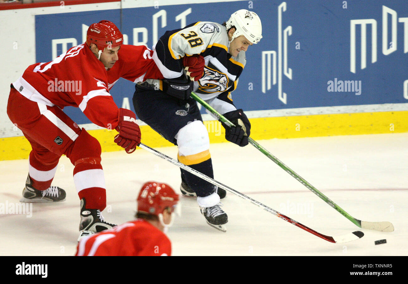 Detroit Red Wings defenseman Mathieu Schneider (23) holds Nashville Predators center Vernon Fiddler (38) as he goes to the net in the third period at Joe Louis Arena in Detroit, MI on January 24, 2006.  Schneider received a two-minute penalty for holding on the play.  The Predators defeated the Red Wings 2-1.  (UPI Photo/Scott R. Galvin) Stock Photo