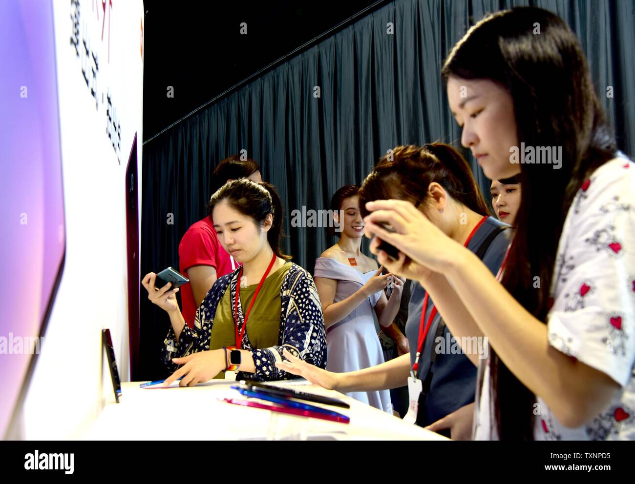 Taibei, China's Taiwan. 25th June, 2019. People try the newly released products of Chinese mobile phone and electronics maker Xiaomi in Taipei, southeast China's Taiwan, June 25, 2019. Credit: Zhu Xiang/Xinhua/Alamy Live News Stock Photo
