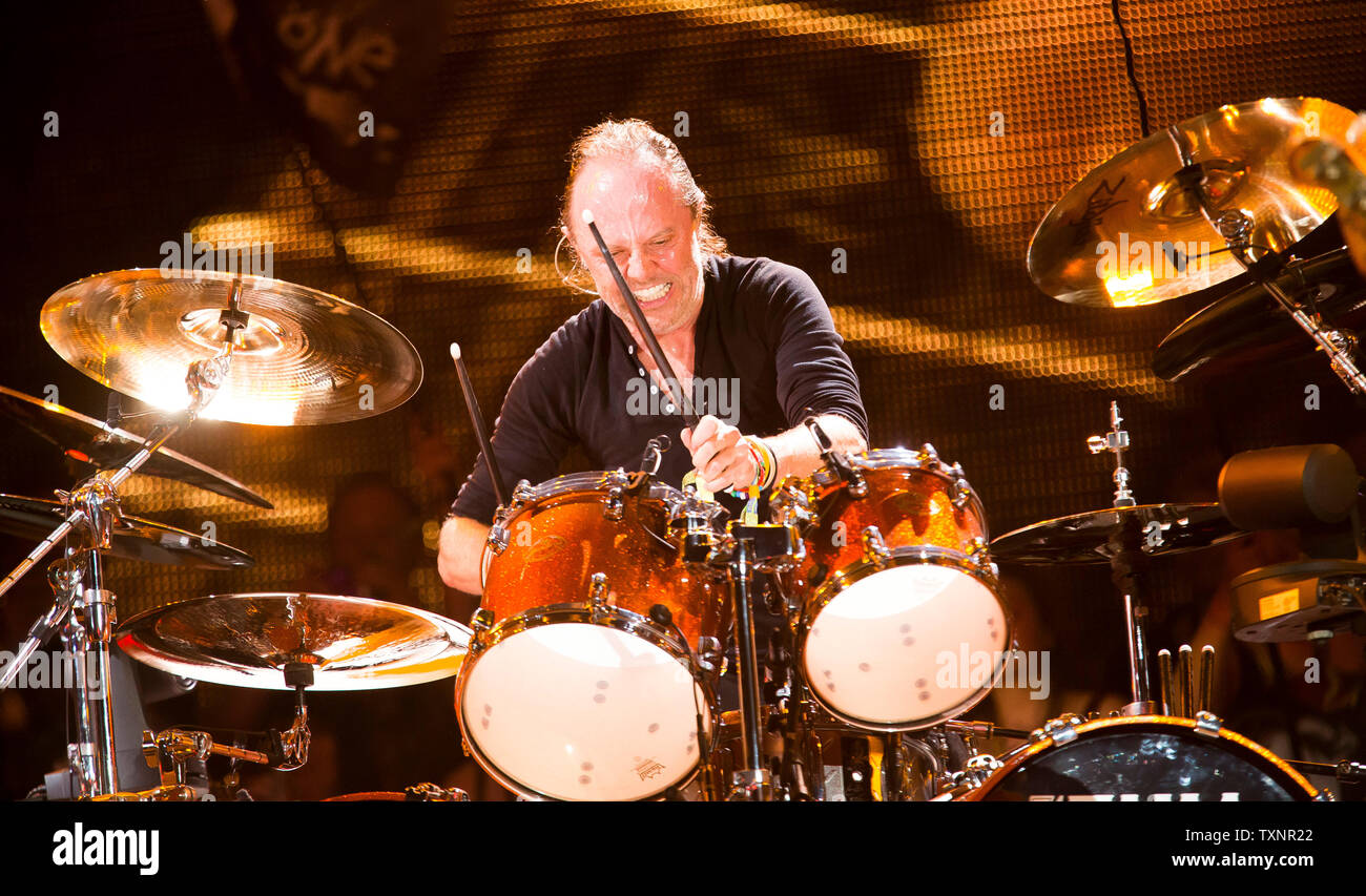Drummer Lars Ulrich from heavy metal band Metallica drums as they headline Glastonbury Festival's Pyramid stage. Glastonbury Festival of Contemporary Performing Arts is the largest music festival in UK, attracting over 135,000 people each to Pilton, Somerset. Stock Photo