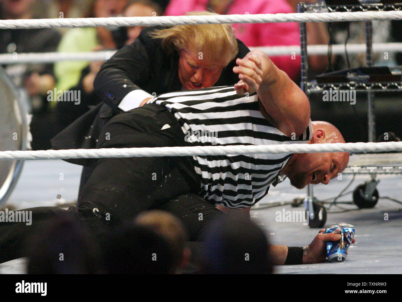 Donald Trump shoves referee Stone Cold Steve Austin following the Battle of the Billionaires match during Wrestlemania 23 at Ford Field in Detroit on April 1, 2007.  Trump's wrestler, Bobby Lashley, defeated WWE Chairman Vince McMahon's wrestler, Umaga.  (UPI Photo/Scott R. Galvin) Stock Photo