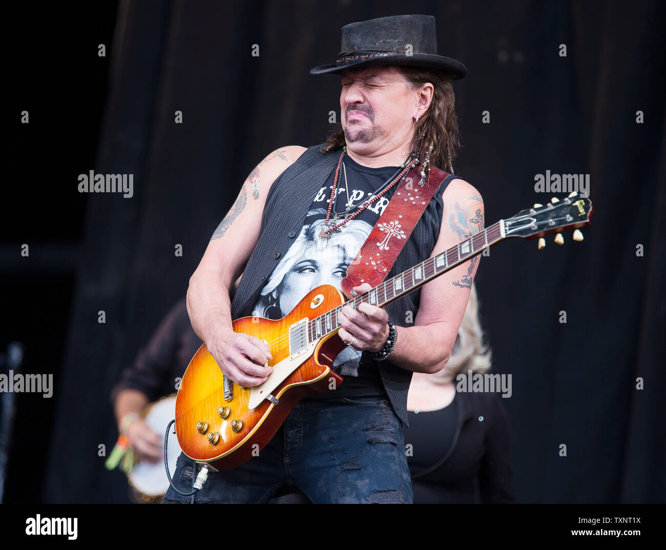 Bon Jovi guitarist Richie Sambora plays Lay Your Hands On Me with American country star Dolly Parton on the main Pyramid Stage of Glastonbury Festival in 2014. Glastonbury Festival of Contemporary Performing Arts is the largest music festival in UK, attracting over 135,000 people each to Pilton, Somerset. Stock Photo