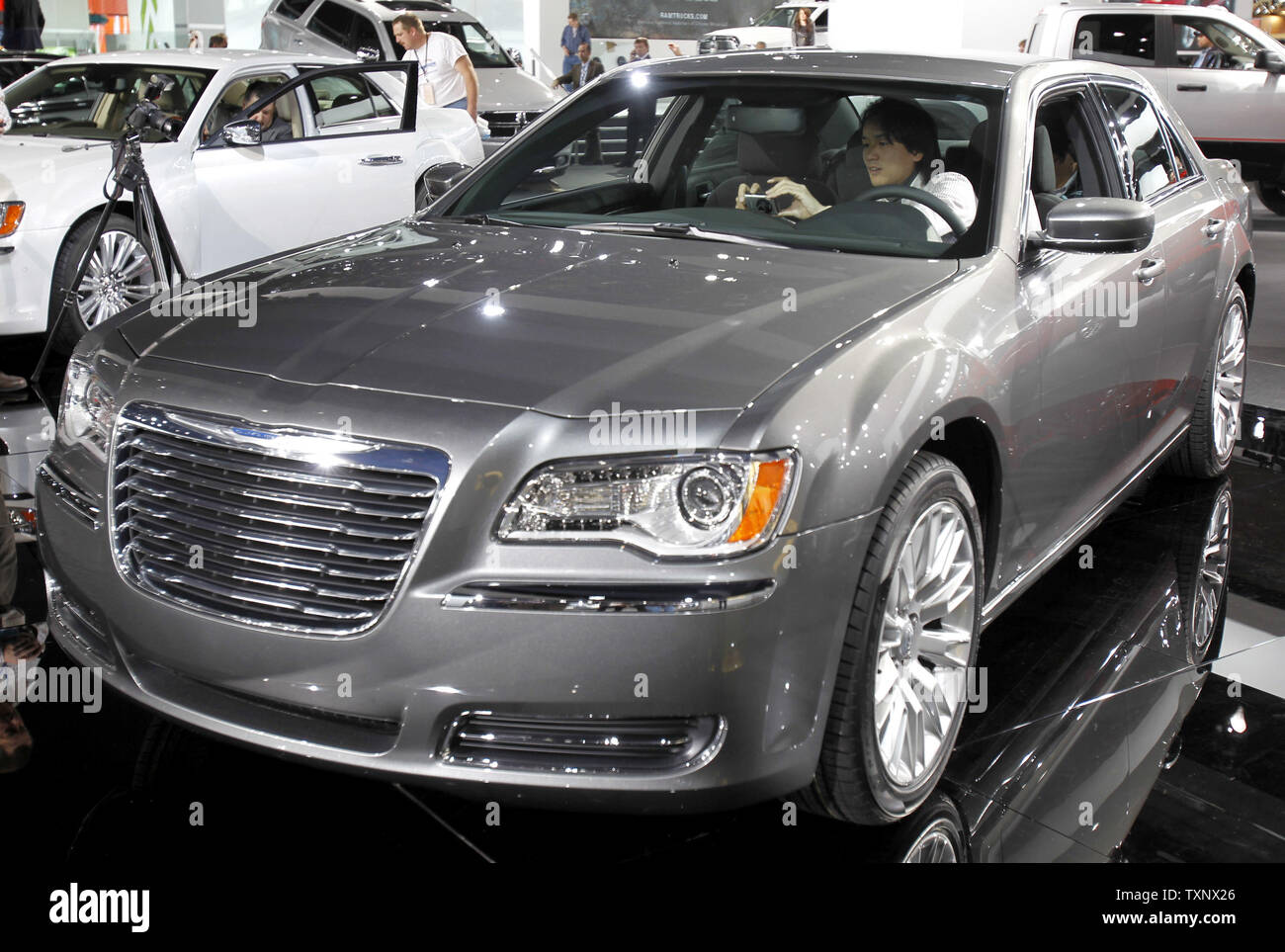An attendee photographs the interior of the redesigned Chrysler 300 at the 2011 North American International Auto Show at the Cobo Center in Detroit, January 11, 2011. UPI/Mark Cowan Stock Photo