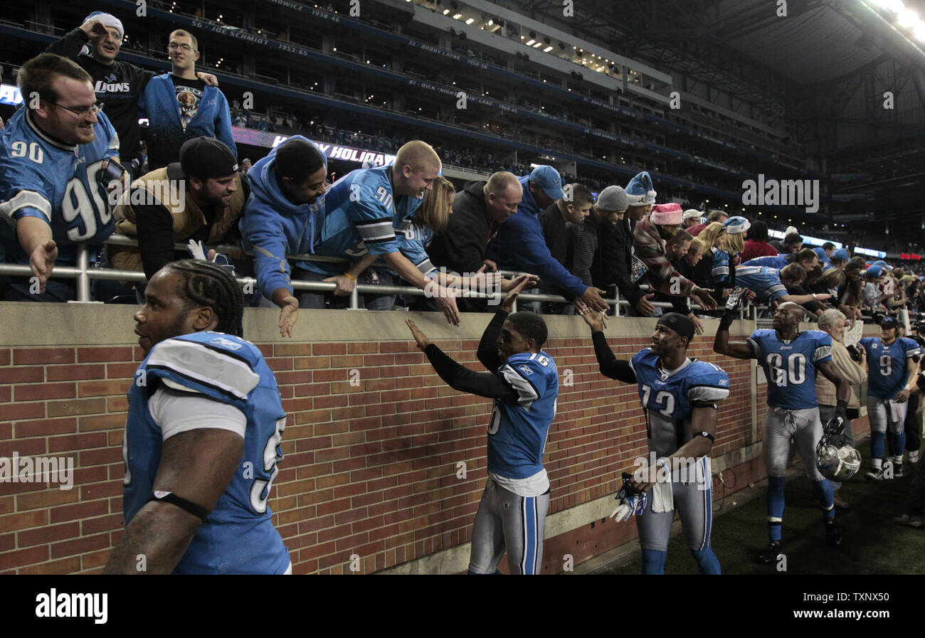 Detroit Lions players shake hands with fans after they defeated