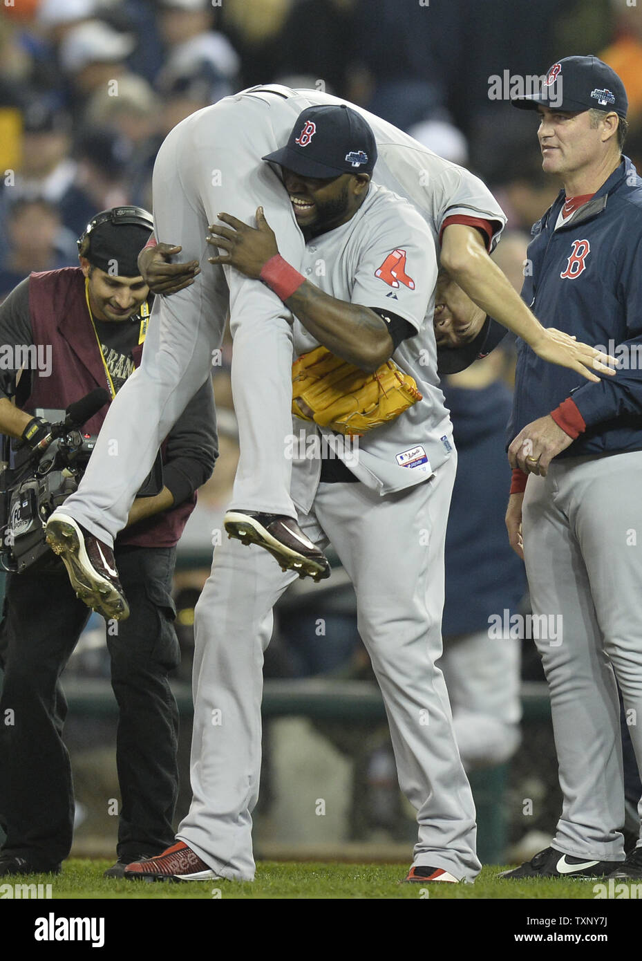 Boston Red Sox David Ortiz picks up reliever Koji Uehara after the last out  against the Detroit Tigers in game three of the American League  Championship Series at Comerica Park in Detroit