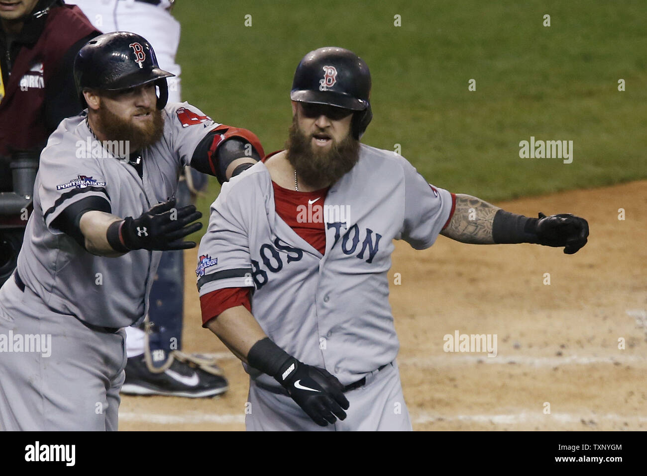Boston Red Sox's Jonny Gomes (L) congratulates Mike Napoli after Napoli hit  a solo home run during the second inning of Game 5 of the American League  Championship Series against the Detroit