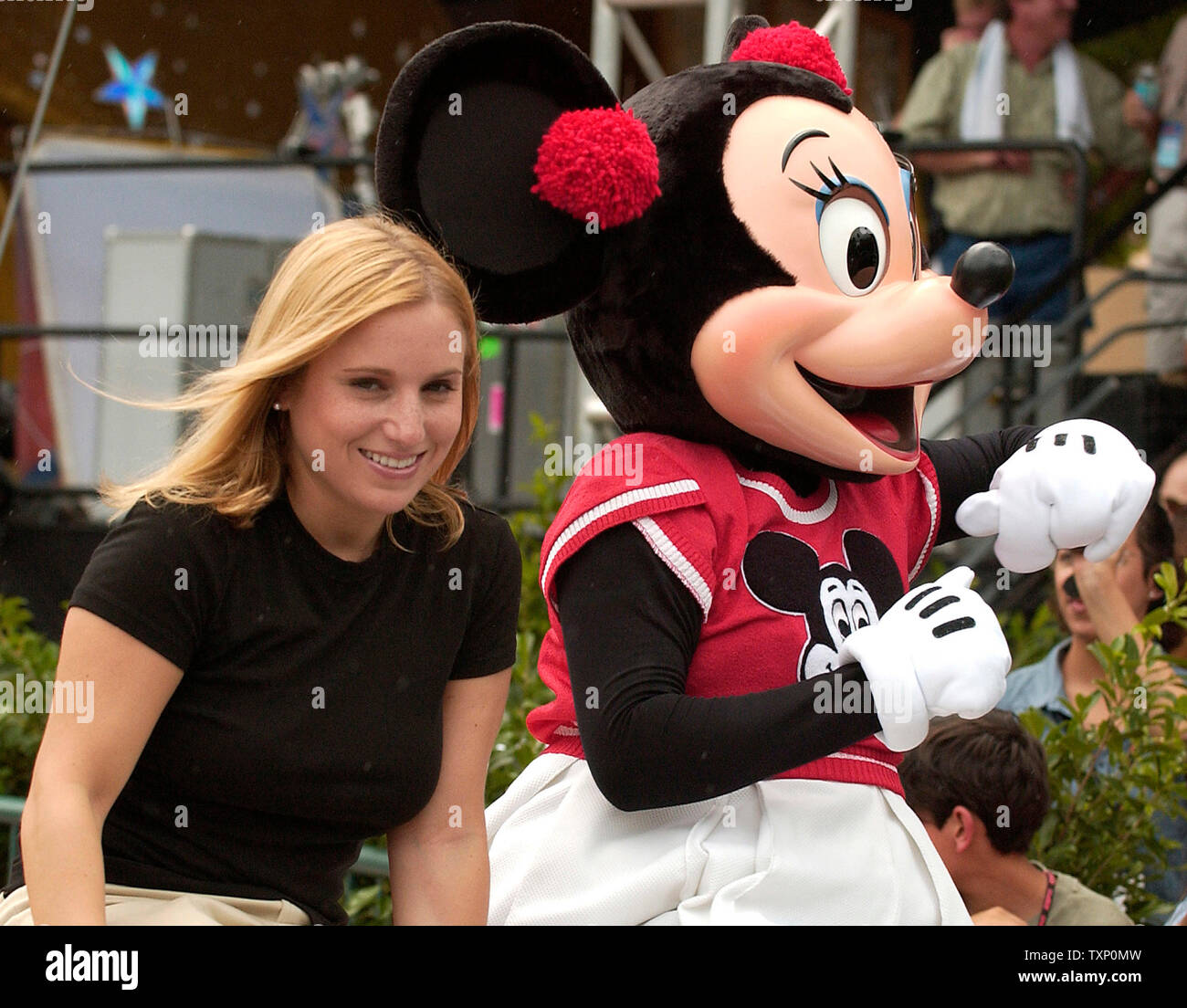 Olympic Gold Medalist, Kerri Strug is accompanied by Minnie Mouse during the celebrity motorcade on July 31, 2004 at Disney's MGM Studios in Orlando, Florida, during the ESPN 25th anniversary celebration. (UPI Photo Marino / Cantrell) Stock Photo